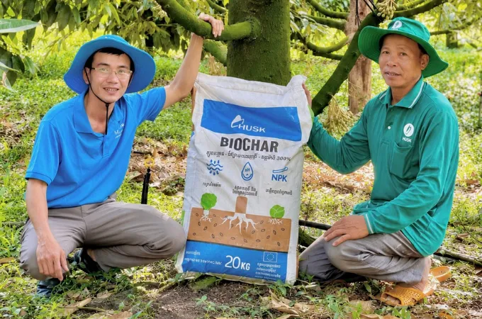 The team showing a 20kg bag of biochar fertiliser.