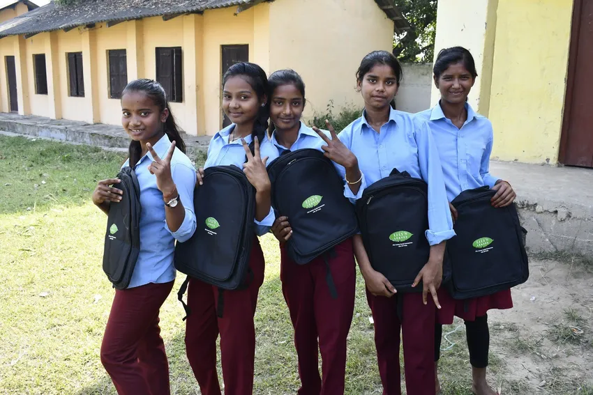 Schoolgirls attending a school supported by Pipal Tree, proud of their new school rucksacks, issued by us to the whole school.