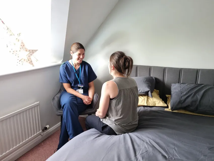 20260701_CNS Harriet smiling with a patient at home
