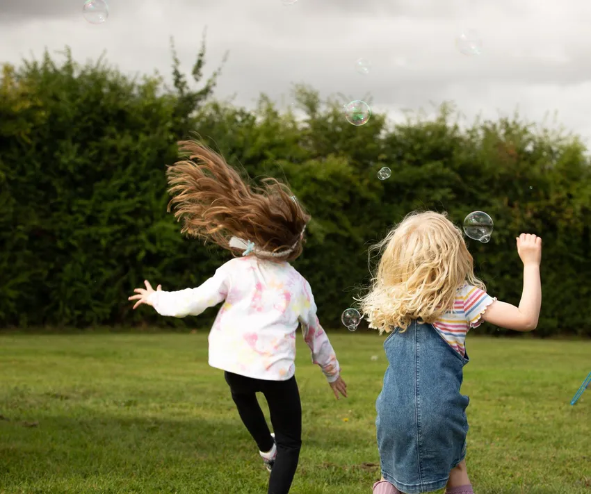Two girls running in a field