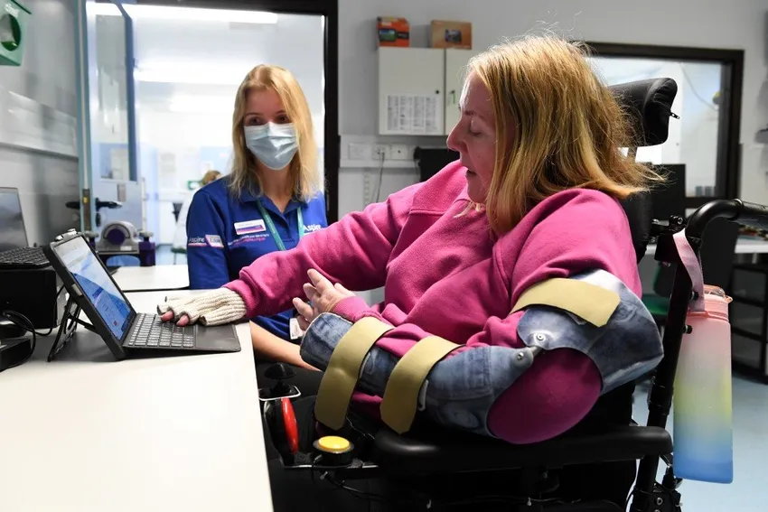 Woman using laptop with the help of Assistive Technologist