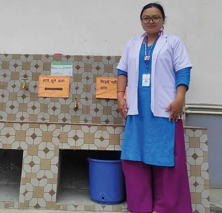 Midwife at water station in the clinic
