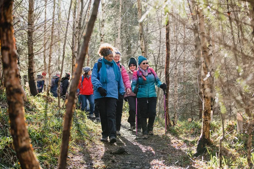 RS1219_Group of women walking through a forest_scr (1)