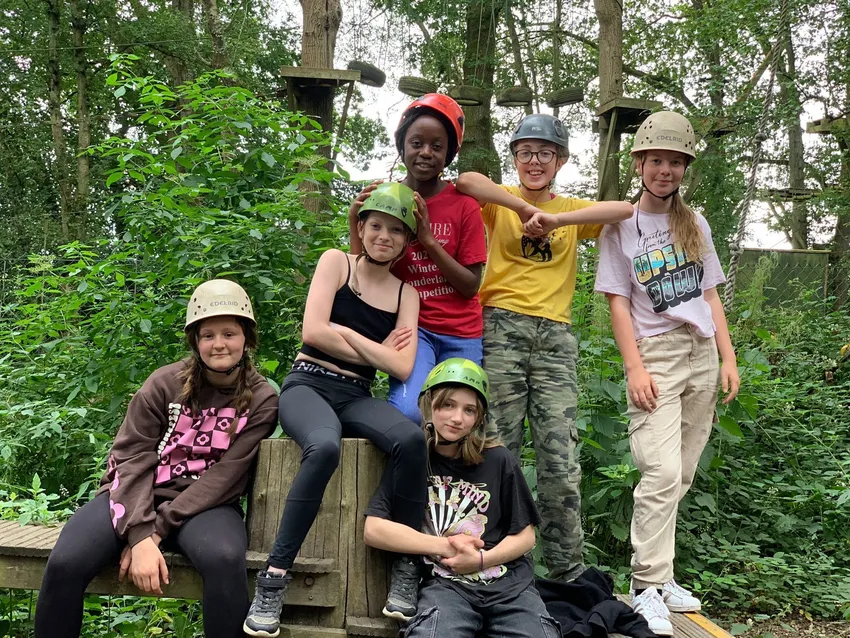 Young people gathered on apparatus at an outdoor pursuits event
