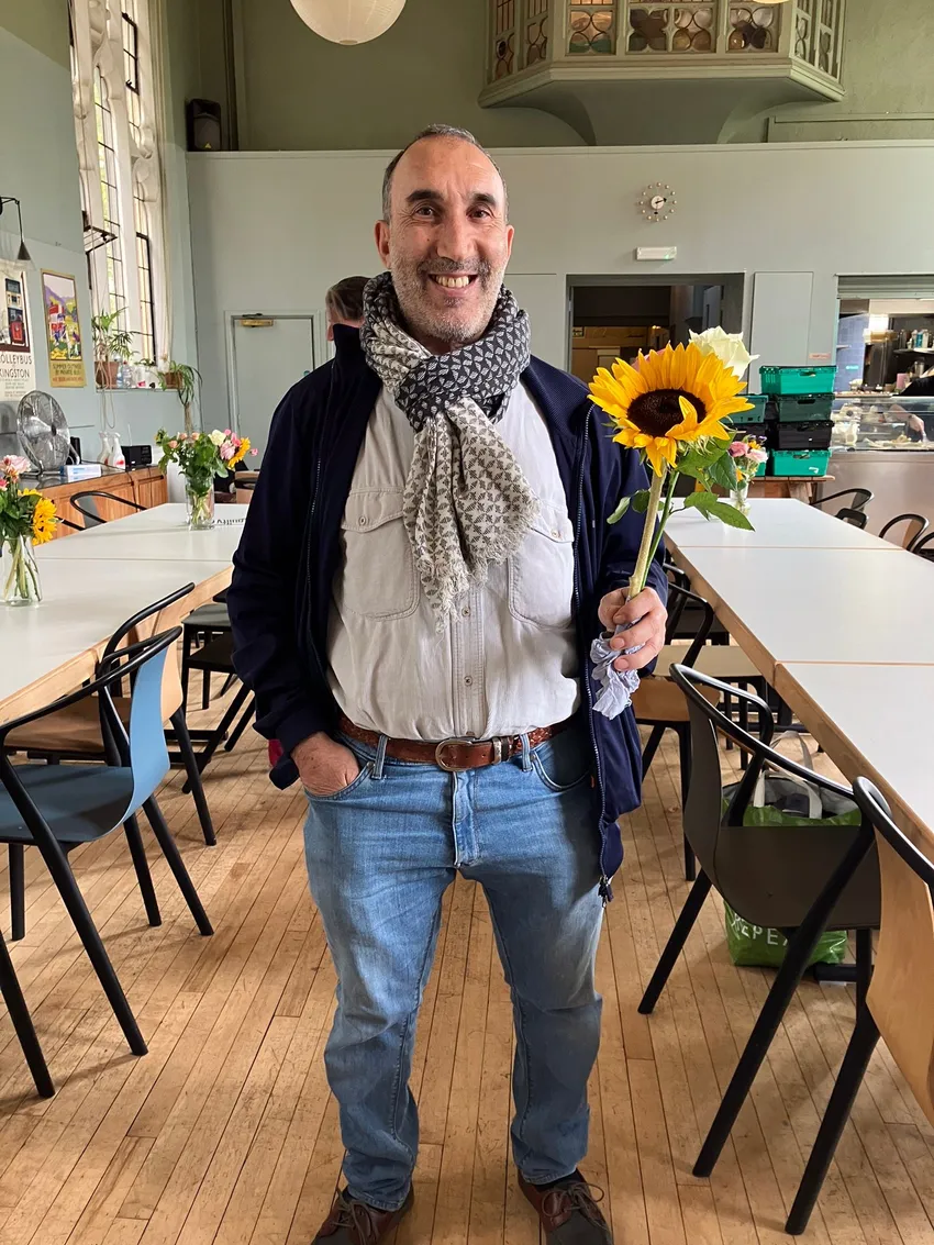 st cuthberts 21.08 malik smiling with sunflower