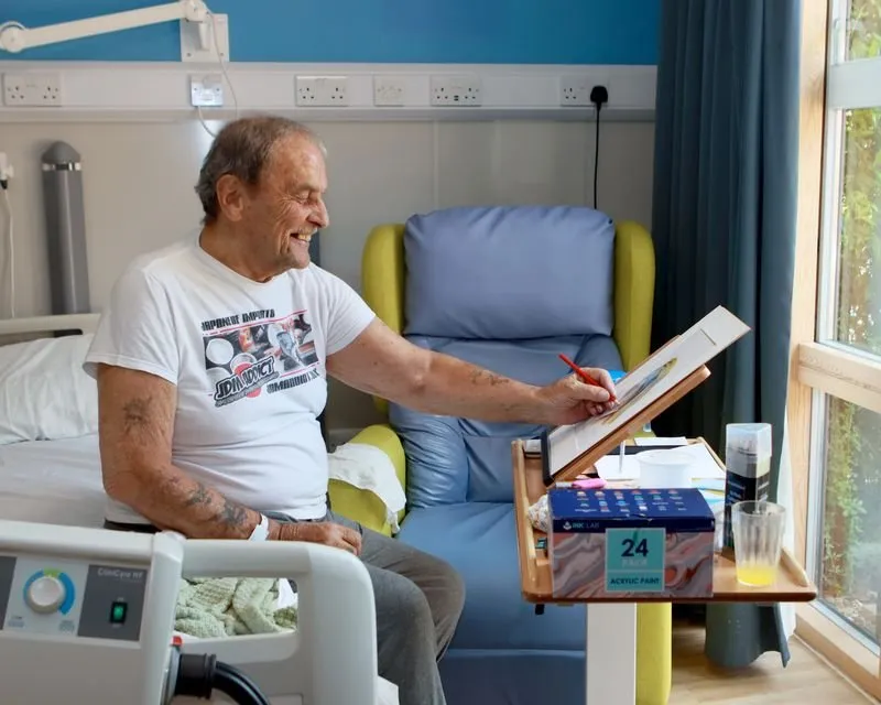 Patient drawing in his bedroom in the Inpatient Unit
