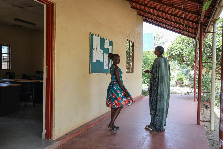 2 female teacher trainee scholars outside their lecture hall in Juba, South Sudan