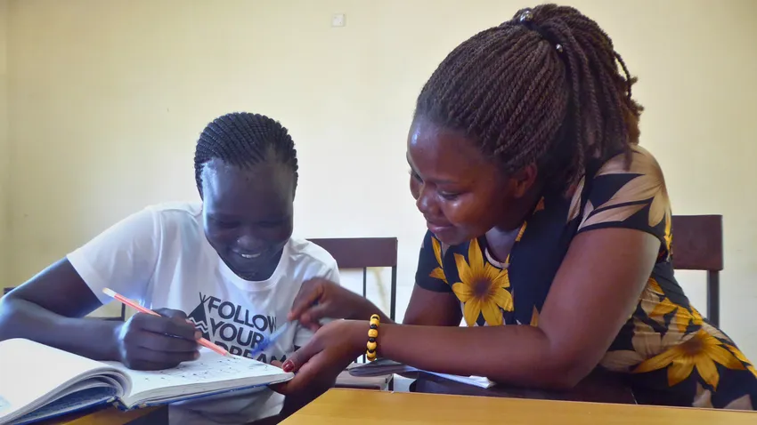 2 female teacher trainee scholars studying in a classroom in Juba, South Sudan