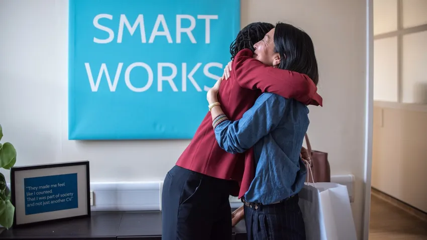 A Smart Works Scotland client hugs a Smart Works Scotland Volunteer after receiving her interview outfit during a Dressing Session.