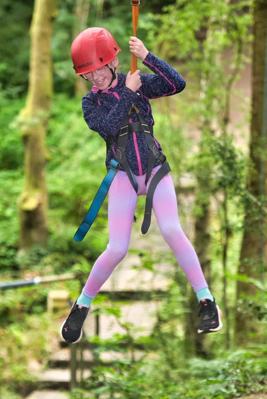 A girl has fun on the zipwire at our HDYES summer camp