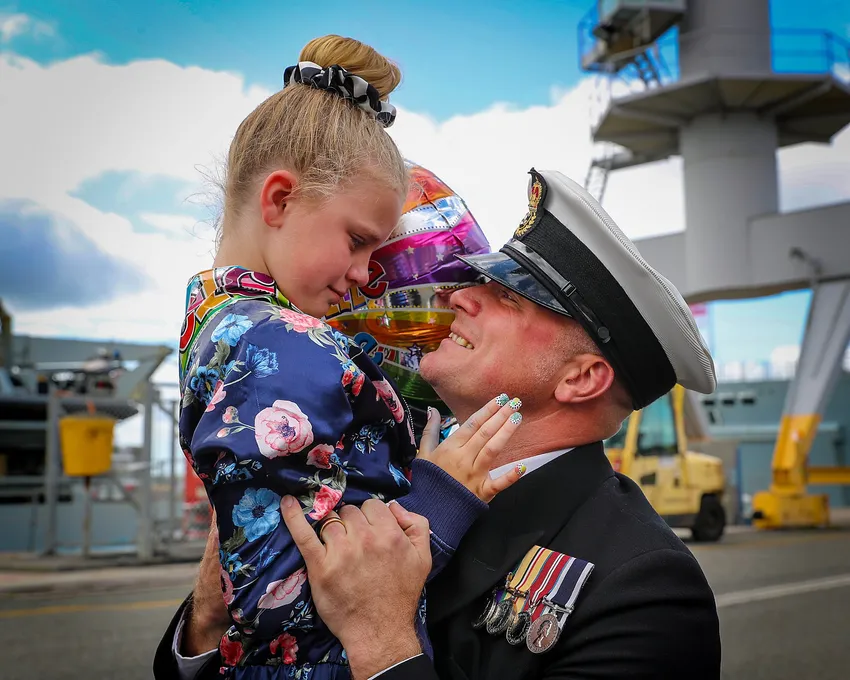 Father holding daughter