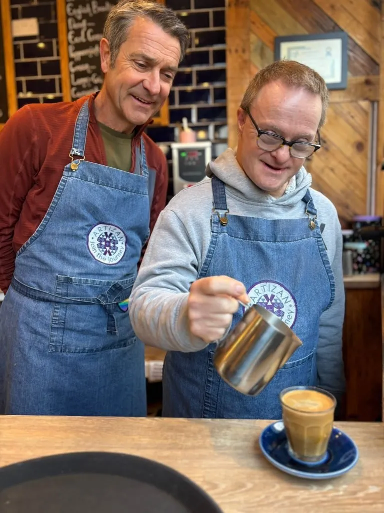 One of our members doing brilliantly with his barista skills! supported by our wonderful volunteers