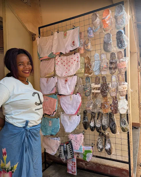 Veronah showing off her new business she started after receiving a loan from Musizi