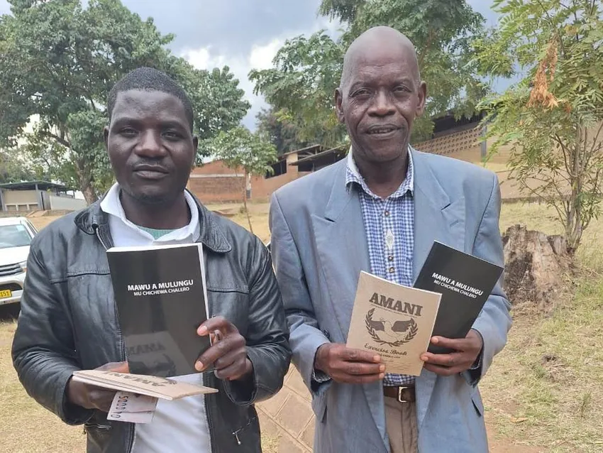 Two male village chiefs holding Bibles who recently attended 'Learn2Server4Chiefs' training.