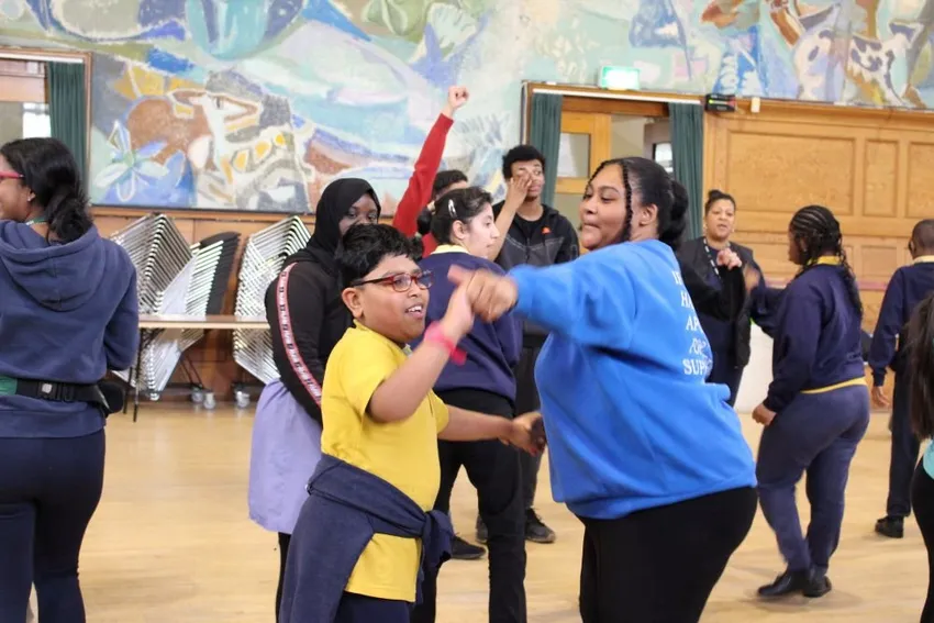 Students from an SEND school dancing together in a hall at Cecil Sharp House. Photo EFDSS. March 2023