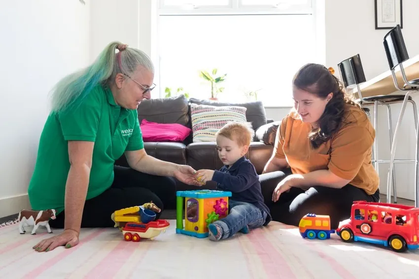 a Family Support Worker working one-to-one with a family.