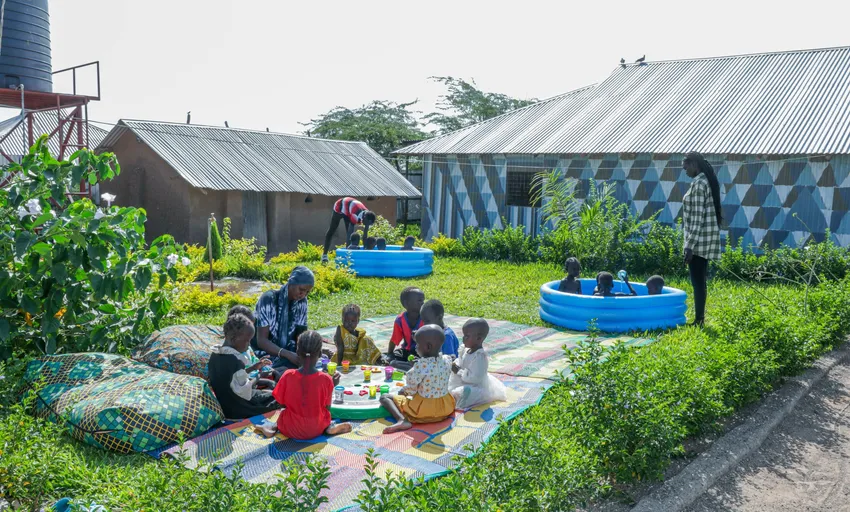 Early Years children playing in paddling pools and enjoying play centred learning in Gatwitch Hub's Garden