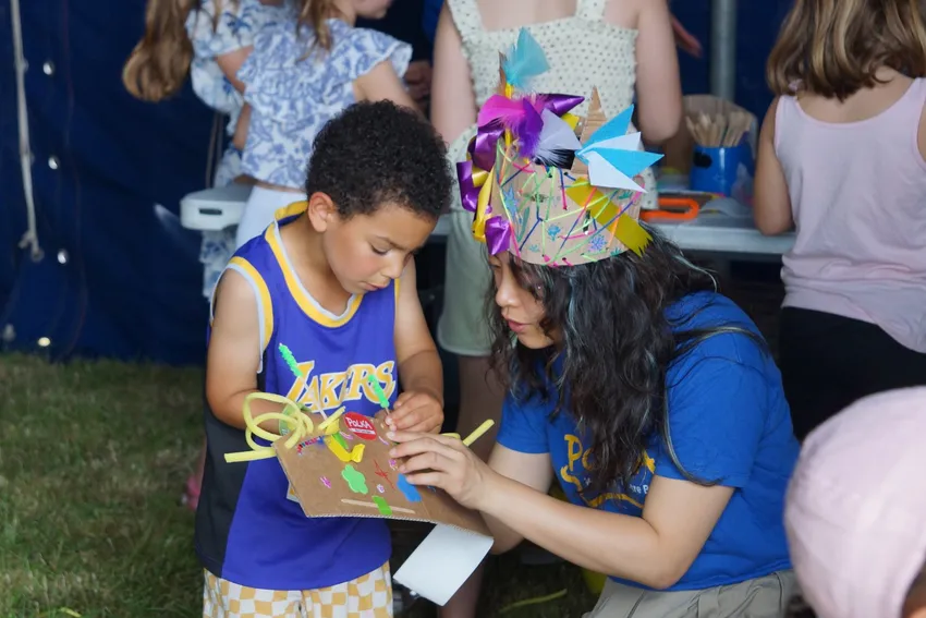A child enjoying a free workshop with Polka