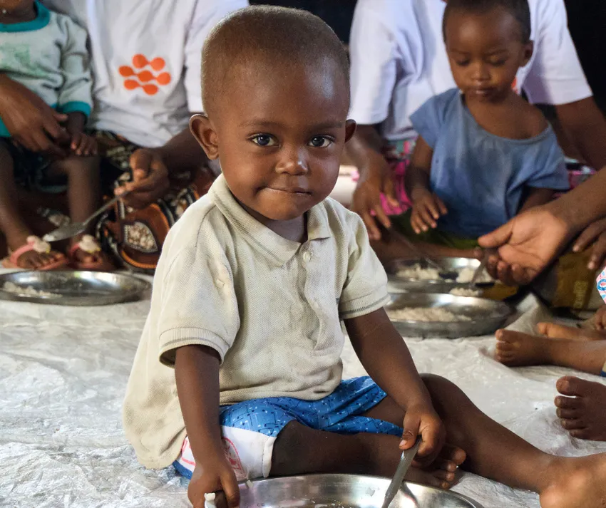4 - Child eating a portion of food from a plate