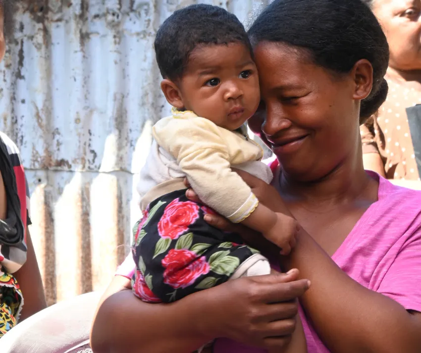 1 - Mother holding her child and smiling