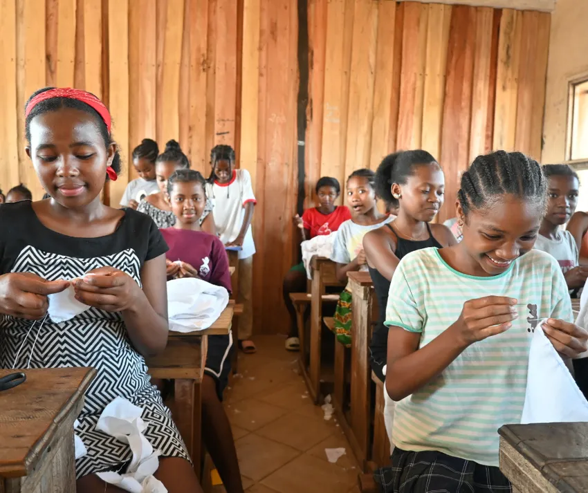 2 - Girls learning pad making in a school