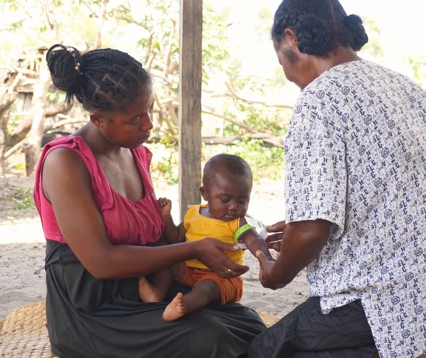 3 - Child being screened for malnutrition by a community health worker