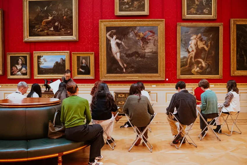 Students participating in an observational drawing class in the gallery