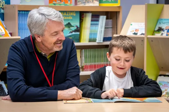 Schoolreader volunteer and pupil enjoying a reading session