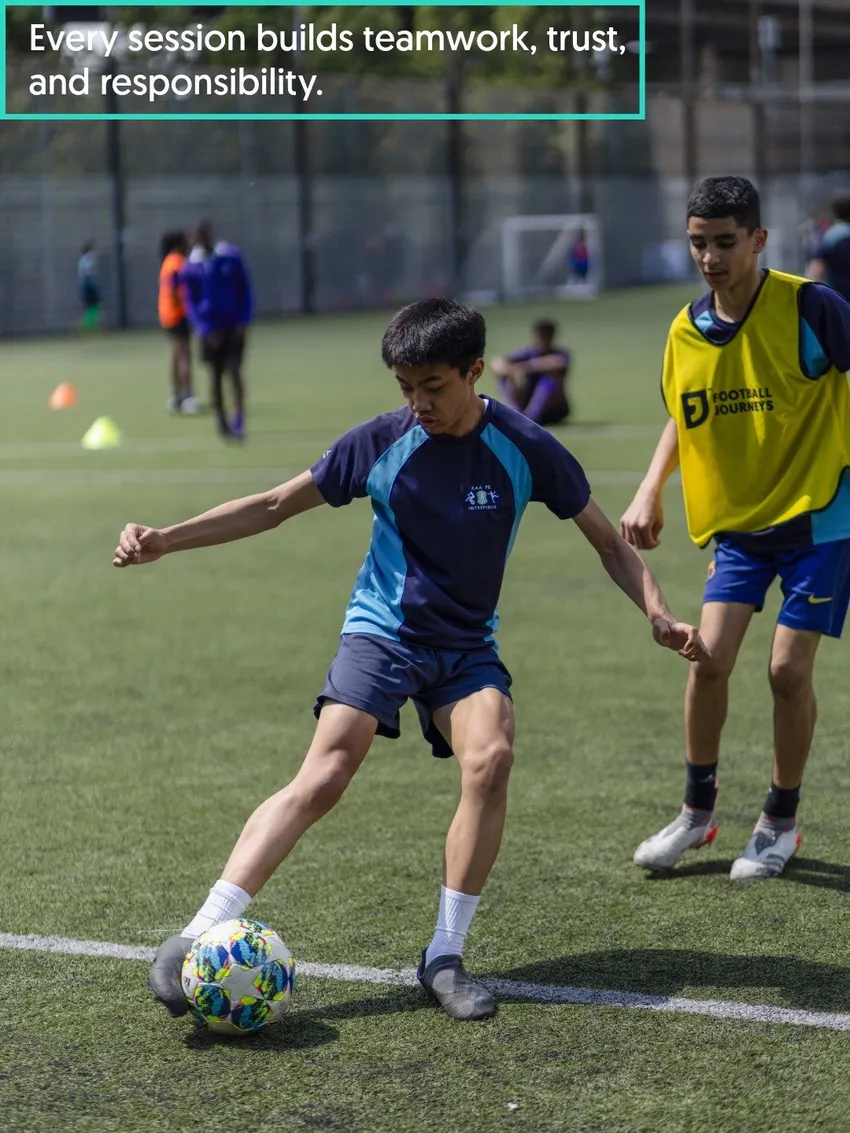 Two teenagers play football at one of our after-school sessions
