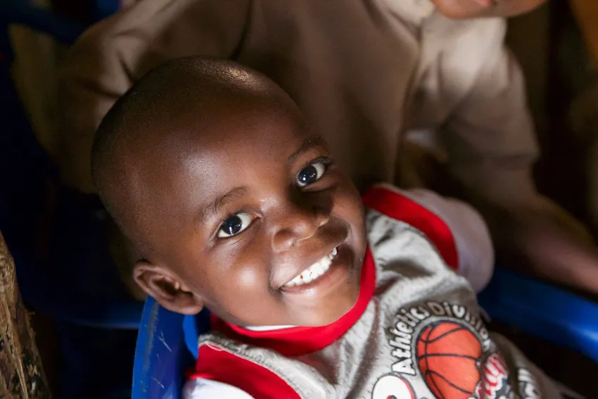 Child smiling at our Encouraging Education Project