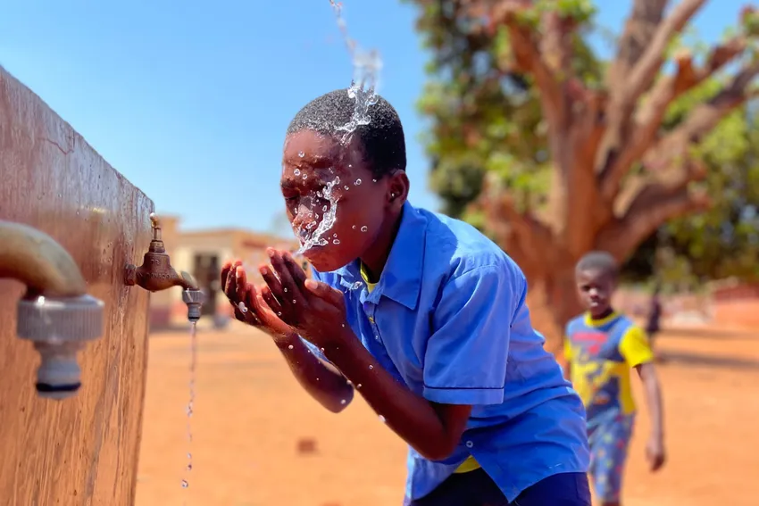 Schoolchild at a waterpoint