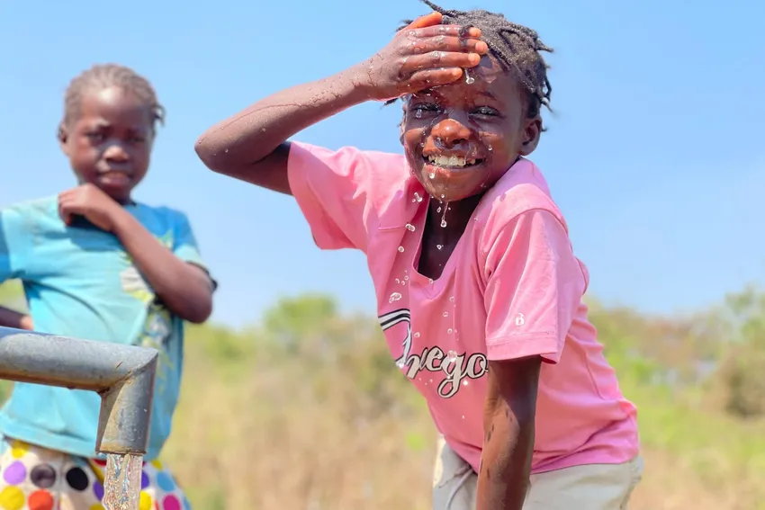 Young girl happy to access water