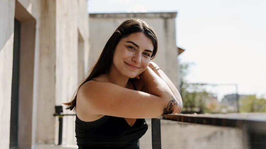 European woman looks contently at the camera