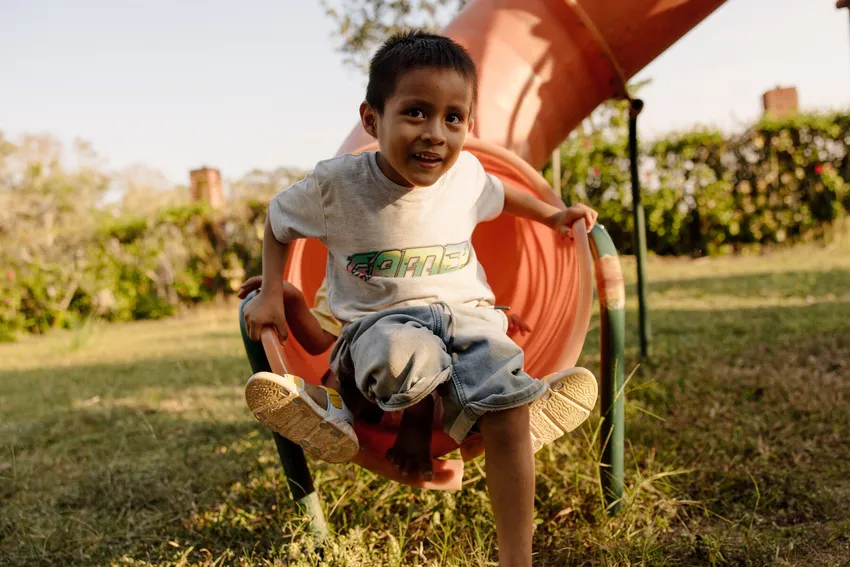 Young boy plays in a park in Peru