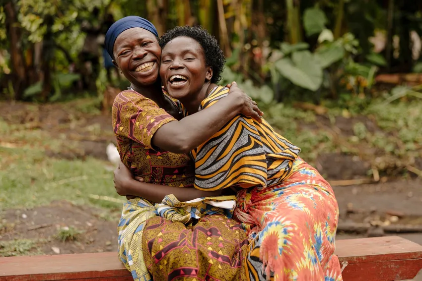 Two survivors of violence share an embrace in Uganda