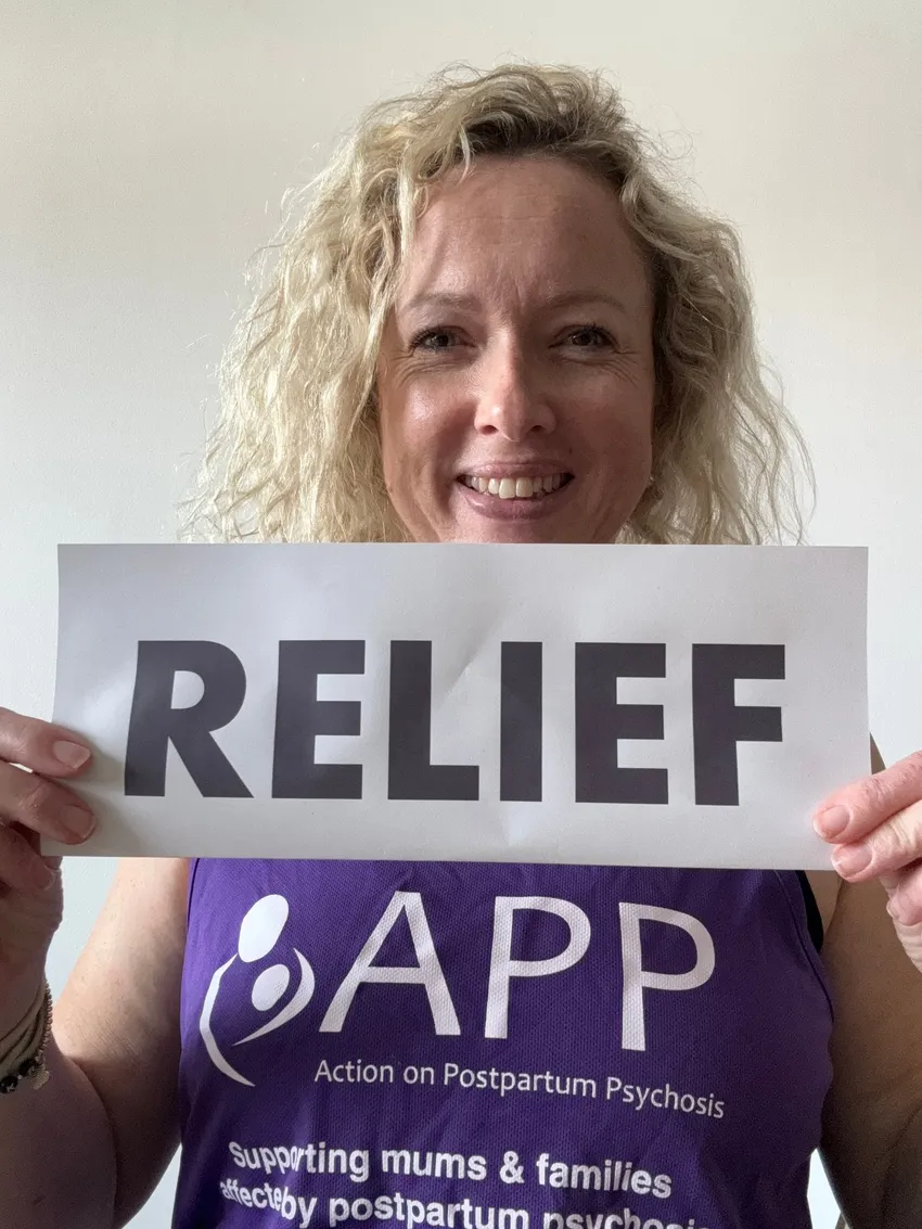 A woman holding a sign saying 'relief'