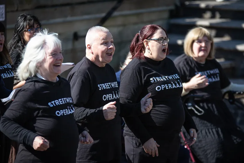 Four Streetwise Opera performers singing outside