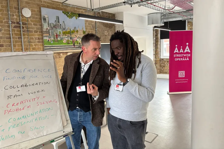 Two facilitators discussing in a workshop.
