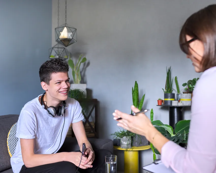 Smiling young man with support worker