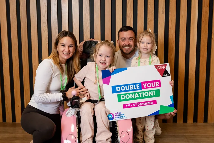 Family holding SMA UK placard