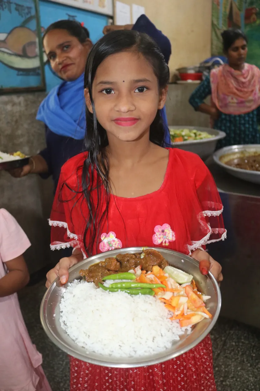 A child with a plate of food
