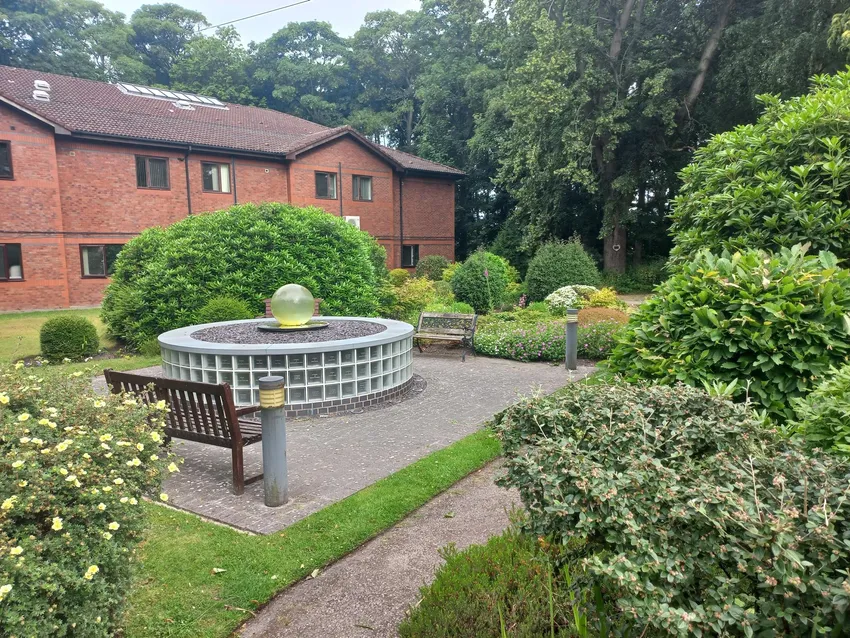 View towards St Francis House. The new sensory garden will incorporate the existing water fountain.