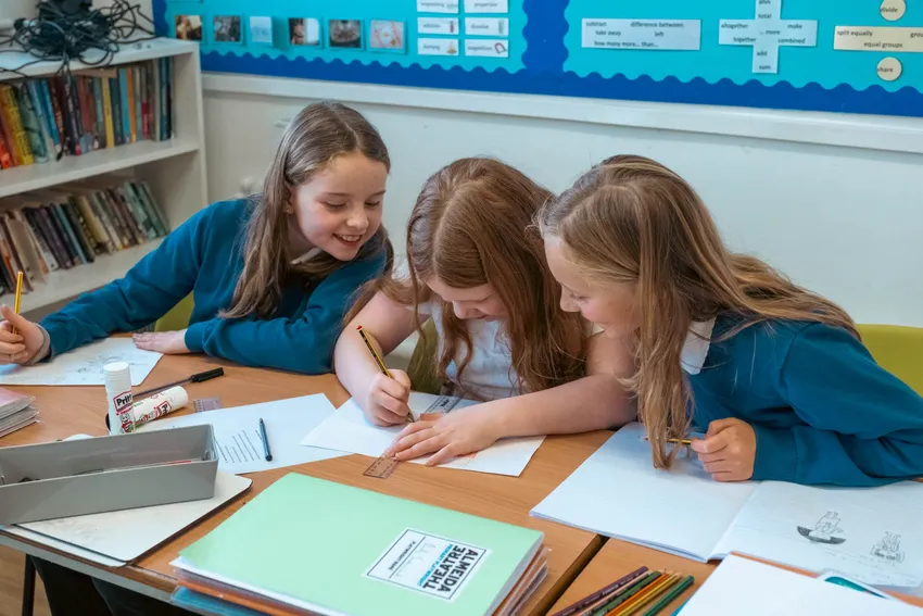 Primary school students create posters for their first-ever plays.