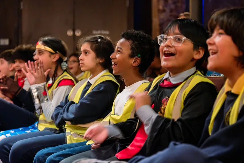 Primary school students sit in the audience at the Almeida Theatre, watching their first plays being performed by professional actors.