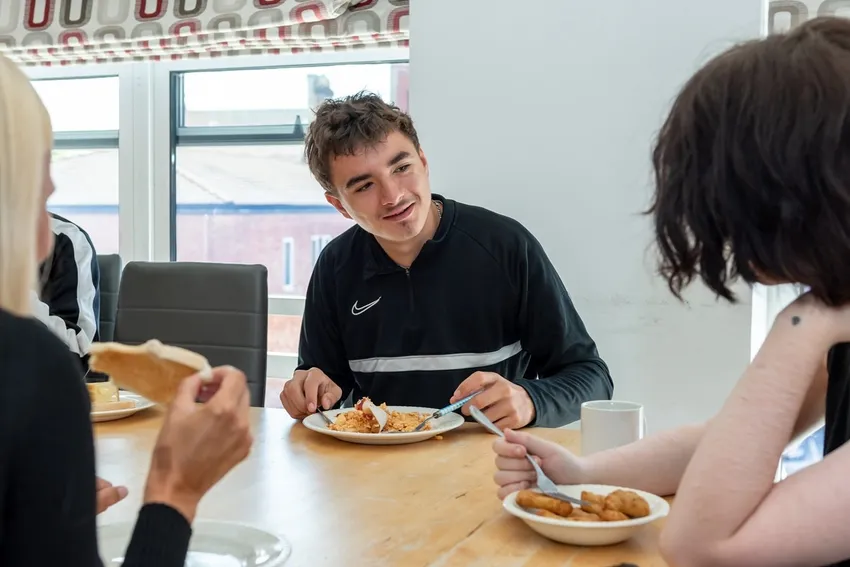 Relaxed young man enjoys time with his peers