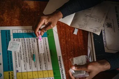 A health worker uses a malaria testing kit in Mpika District, Zambia