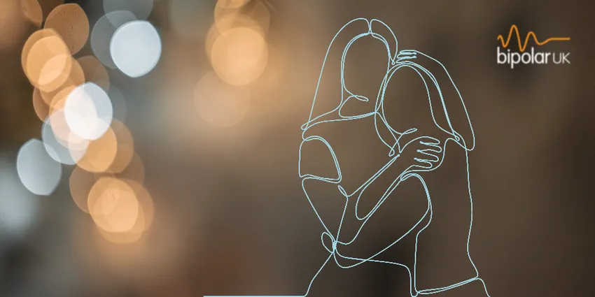 Warm background with a Christmas glow of lights and a line drawing of two women embracing each other