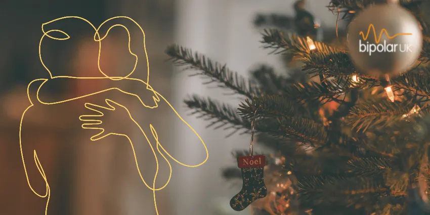 Christmas tree in the background and line drawing of two people hugging