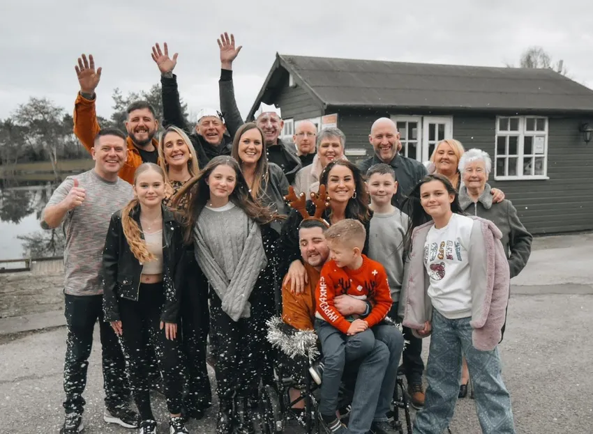 A family enjoying Christmas in July with their seriously ill family member who is in a wheelchair
