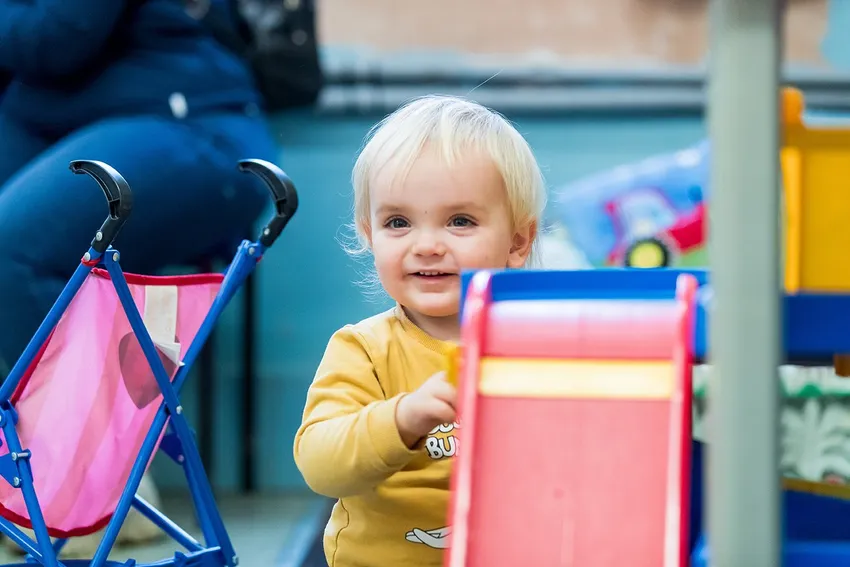 Child at group smiling at camera